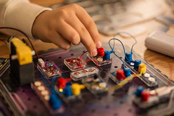 Child building a real circuit on the Labbox board